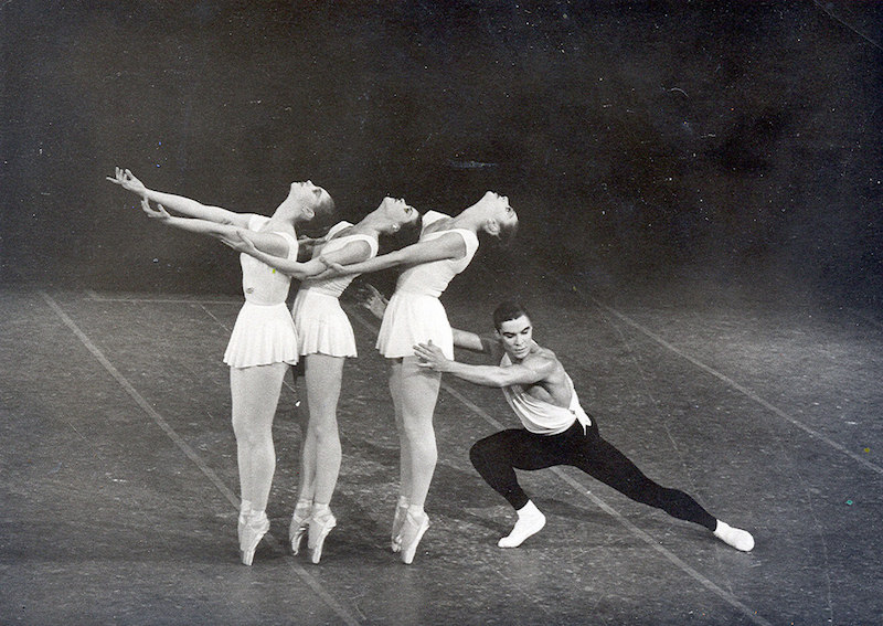 Three female ballet dancers stand on pointe with the heads back while Jacques extends into a lunge behind them
